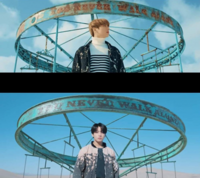 Jungkook stands alone in front of the ferris wheel representing the rotation of time in both MVs